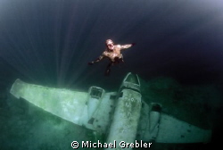 Apnea diver returning to the ice entry hole in Morrison's... by Michael Grebler 